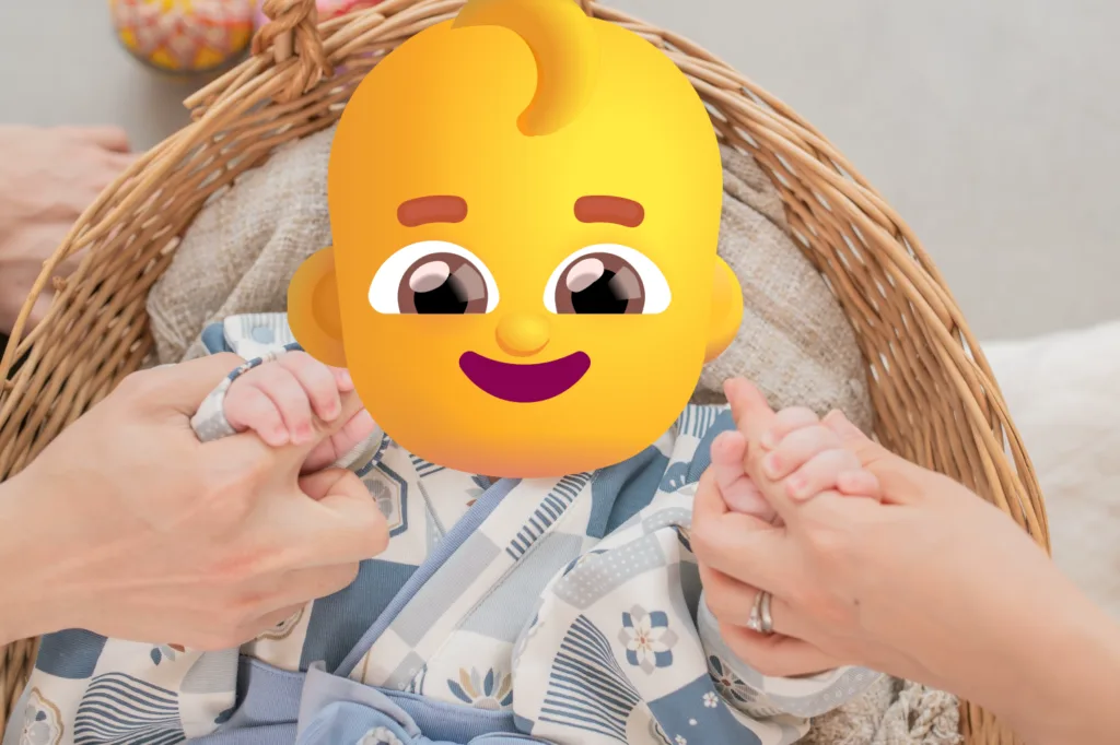 A heartwarming family photo of a baby holding Mom and Dad's fingers.